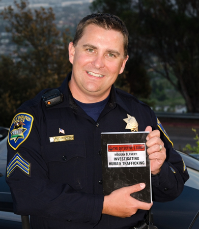 Ryan Cantrell '98 holds a copy of his new book, "Modern Slavery." (Photo: Ryan Cantrell)